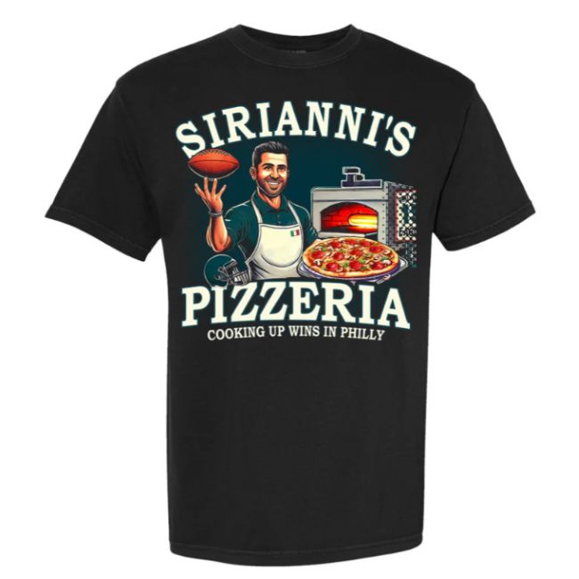 Black t-shirt featuring a design of 'Sirianni's Pizzeria' with a chef holding a football, a pizza oven, and the phrase 'Cooking Up Wins in Philly.