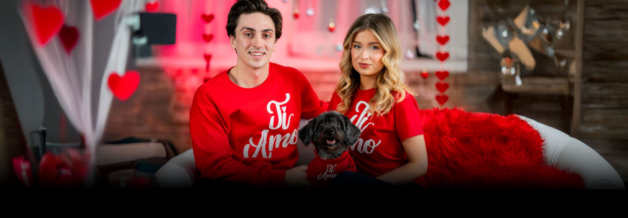 Italian couple on a couch with small dog